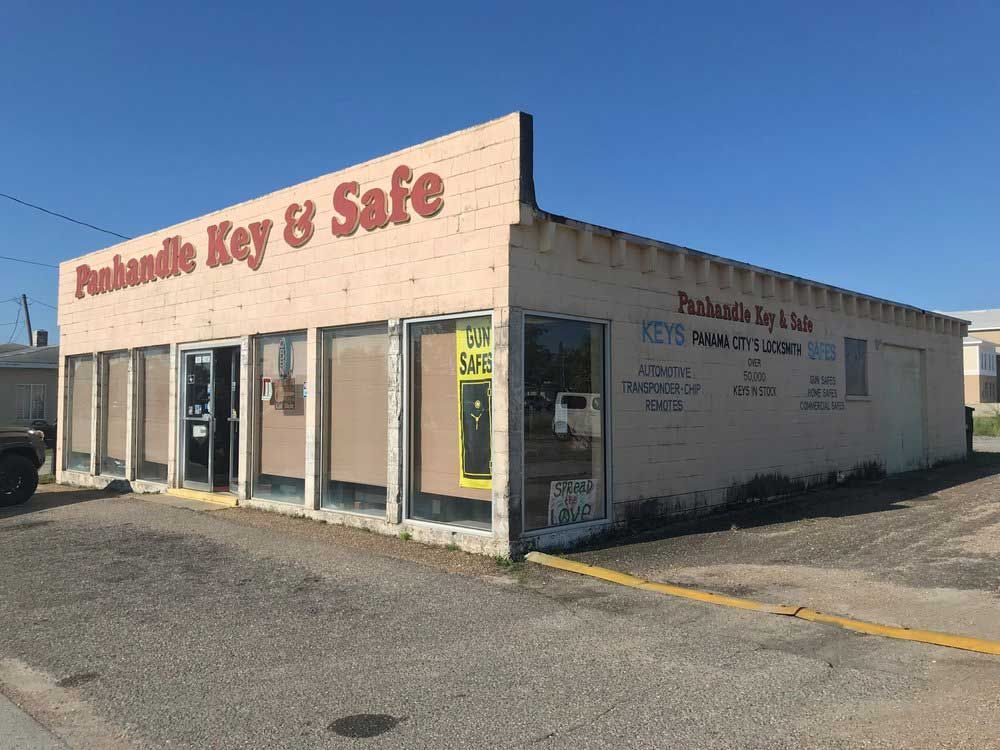A building with a lot of windows and a sign that says pushhandle key & safe.
