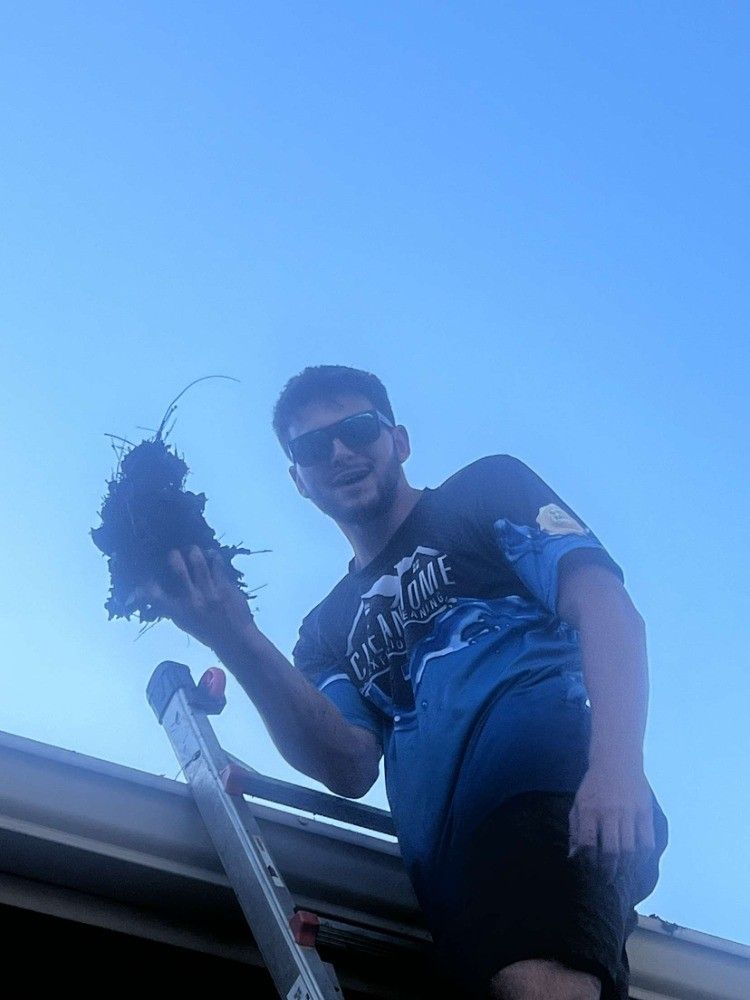 Dirty Gutter Being Cleaned Using Pressure Washing