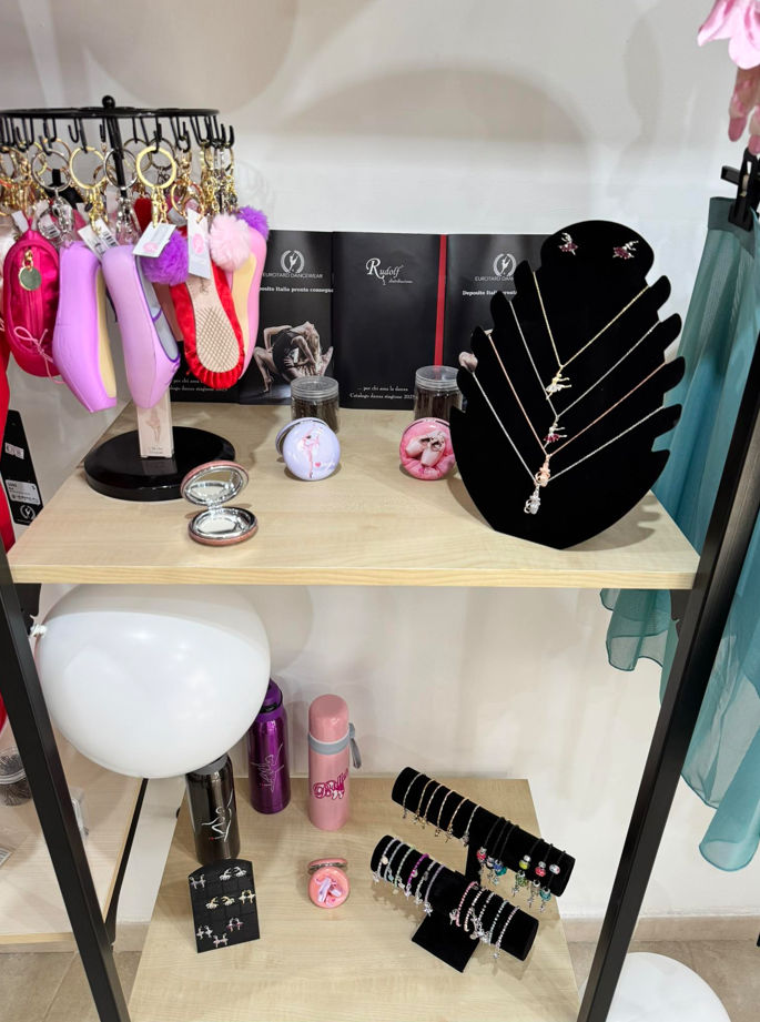 Esposizione al dettaglio con gioielli, portachiavi e piccoli regali sugli scaffali.