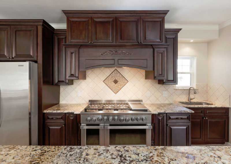 A kitchen with stainless steel appliances and granite counter tops.