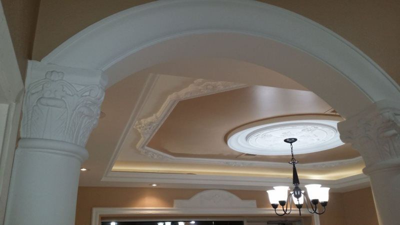 There is a chandelier hanging from the ceiling in the middle of the room.