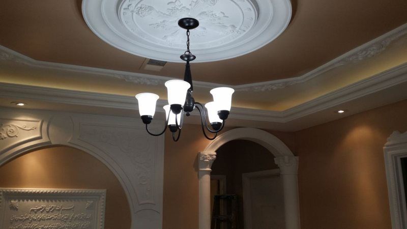 A chandelier is hanging from the ceiling of a room