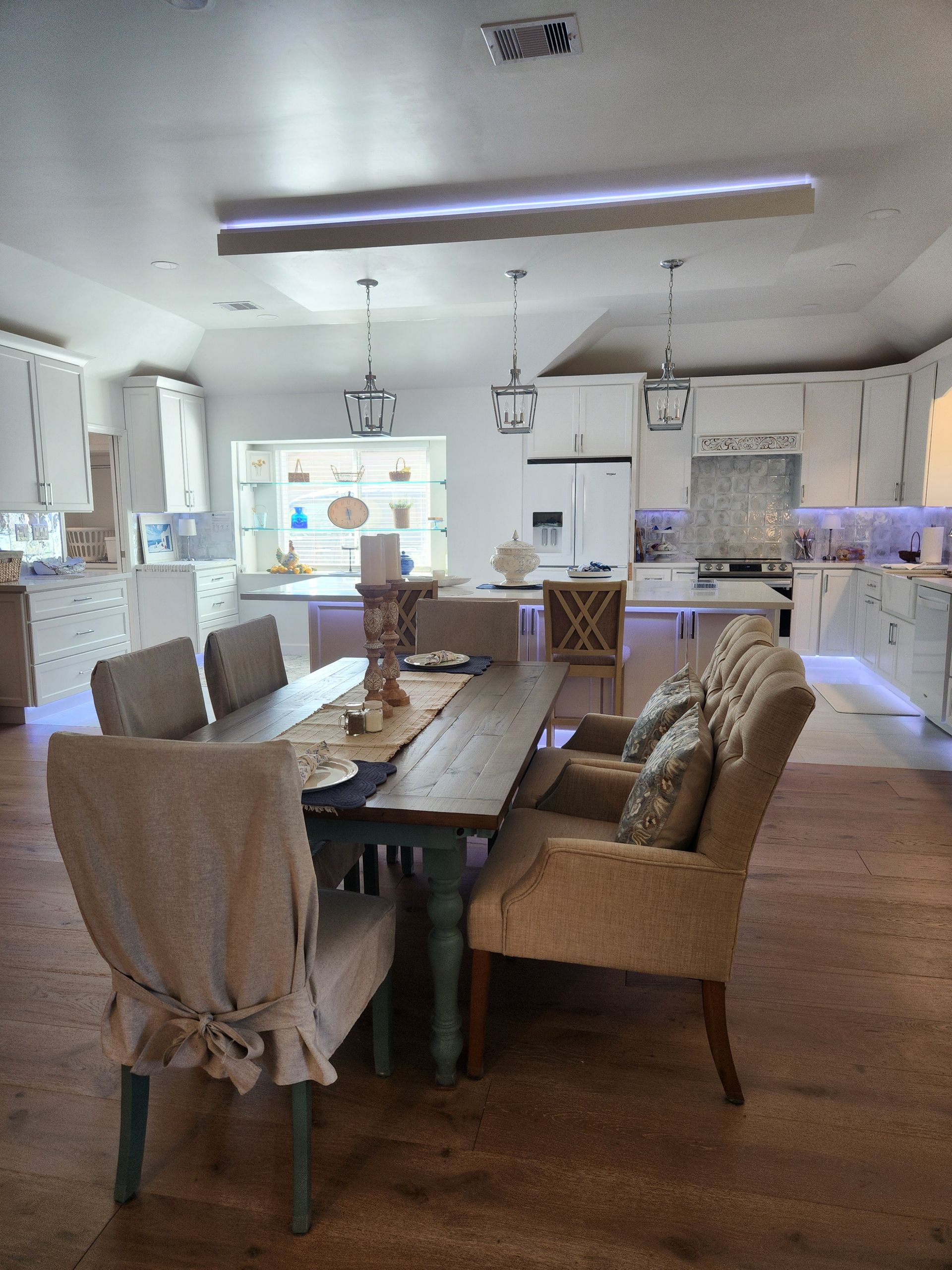 A dining room table with chairs and a bench in a kitchen.