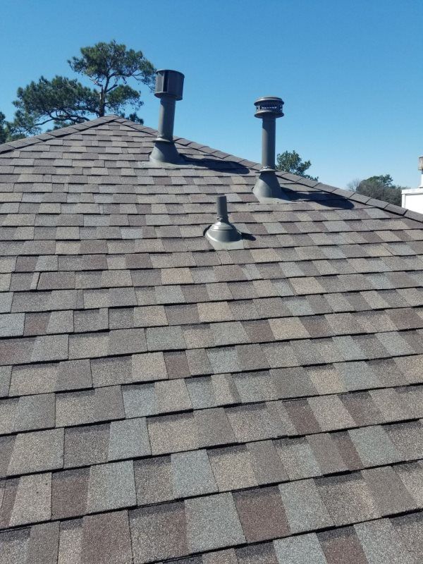 A roof with two chimneys on top of it