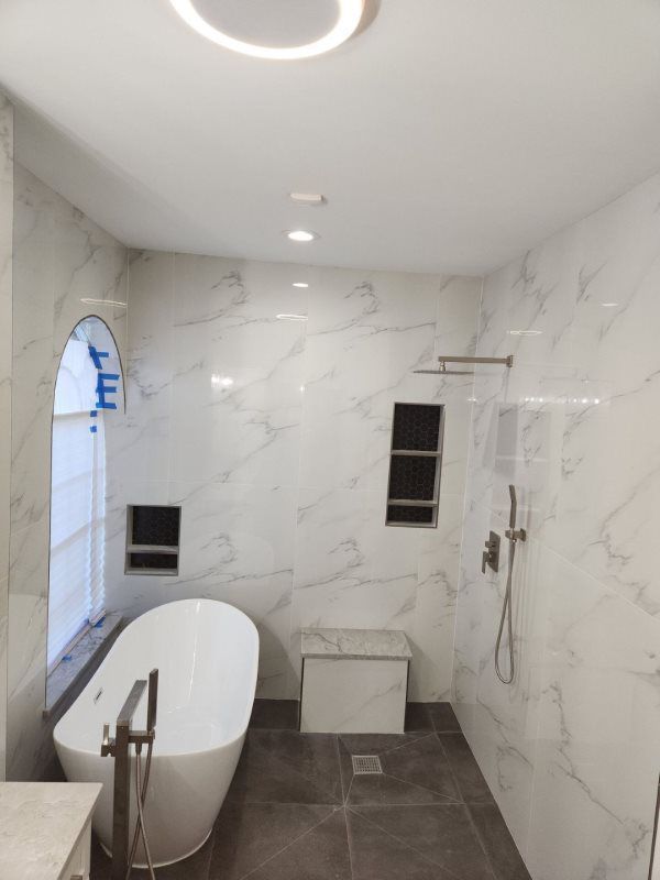 A bathroom with a bathtub and a shower