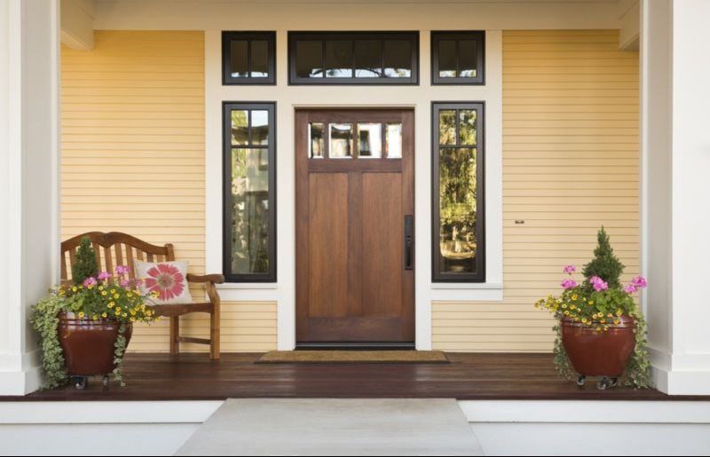 The front door of a house with a wooden door