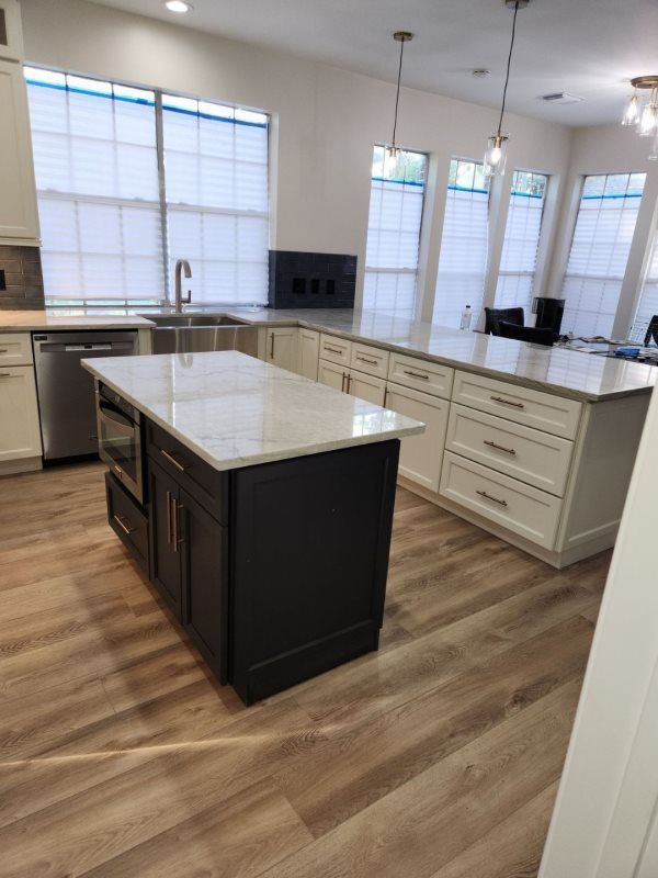 A kitchen with a large island in the middle of it.