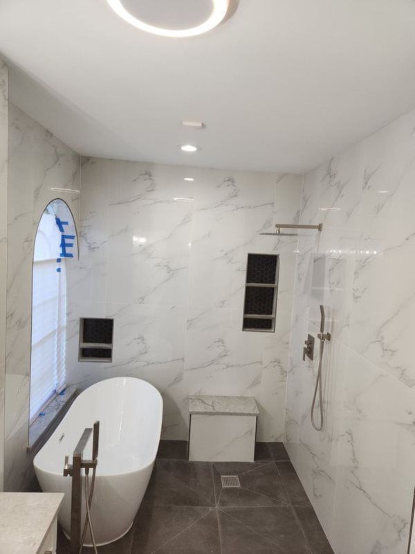 A bathroom with a bathtub and a shower