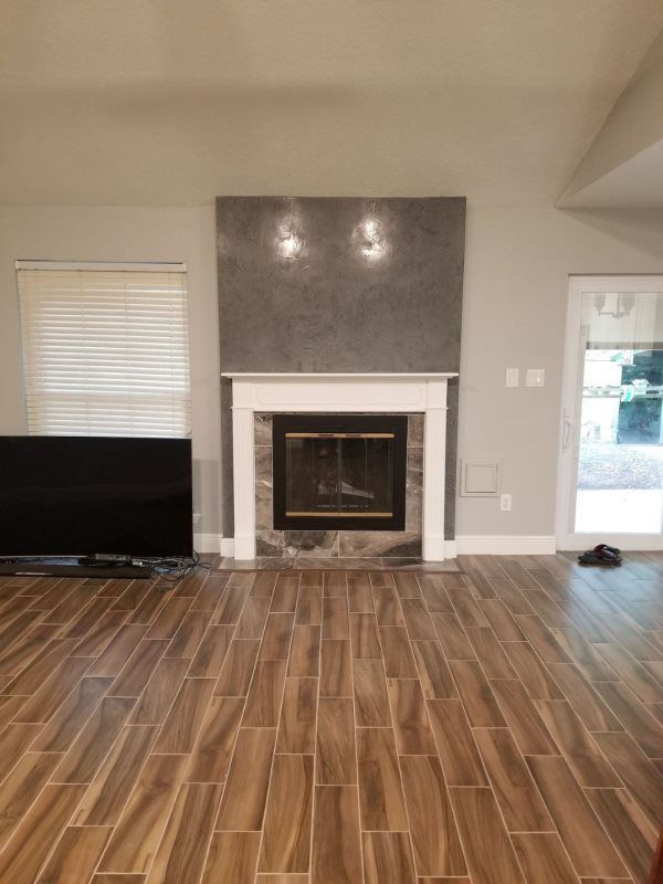 A living room with a fireplace and a flat screen tv.