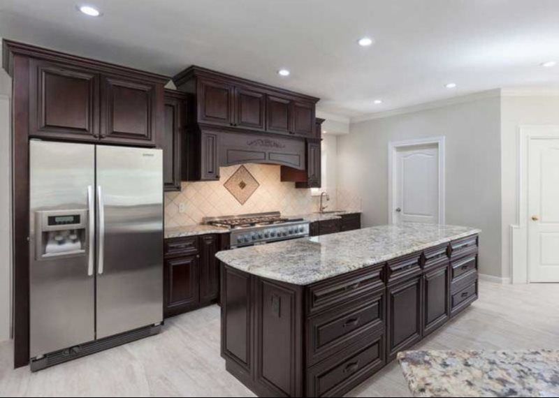 A kitchen with a large island and stainless steel appliances.