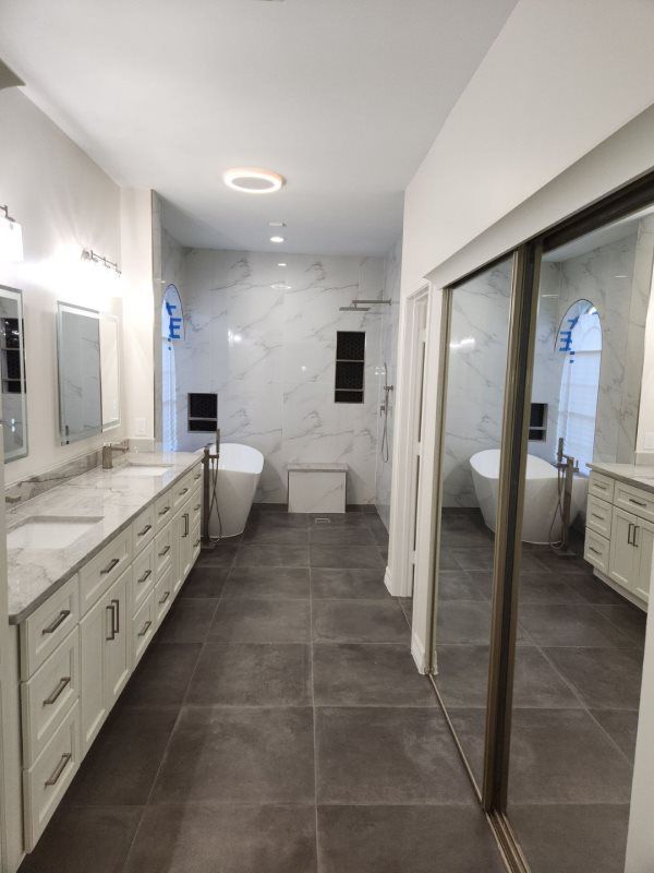 A bathroom with two sinks and a bathtub