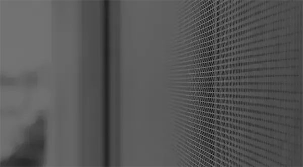 Ein Schwarzweißfoto einer Wand mit einem Gittermuster.