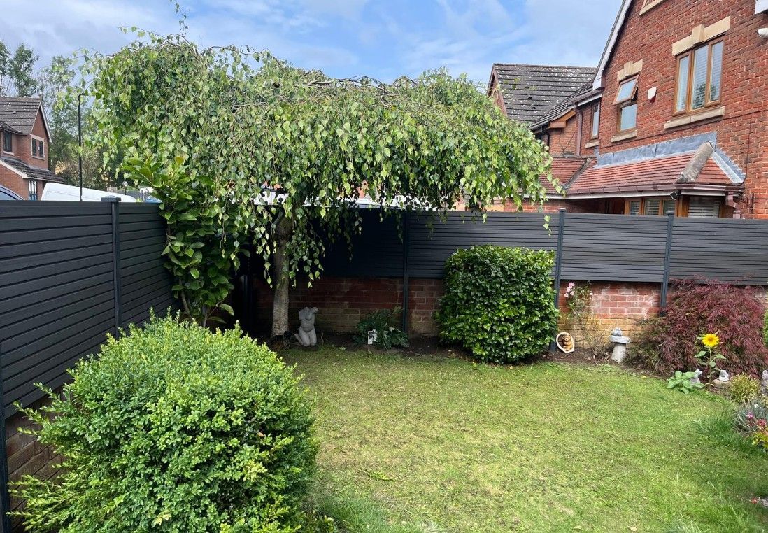 View from inside the garden of composite fencing installation behind a brick wall in a front garden in Sheffield
