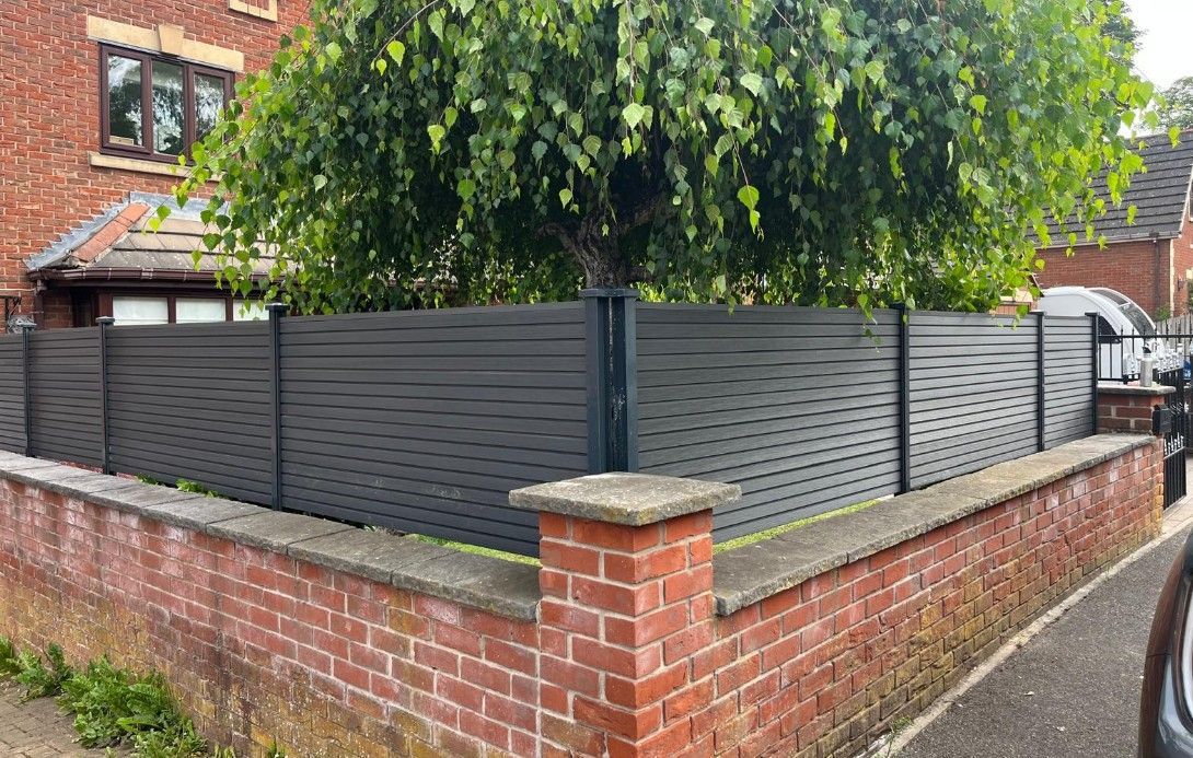 Composite fencing installation behind a brick wall in a front garden in Sheffield