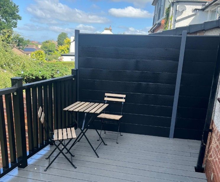 Grey composite fencing installed down one side of a raised composite deck in Sheffield