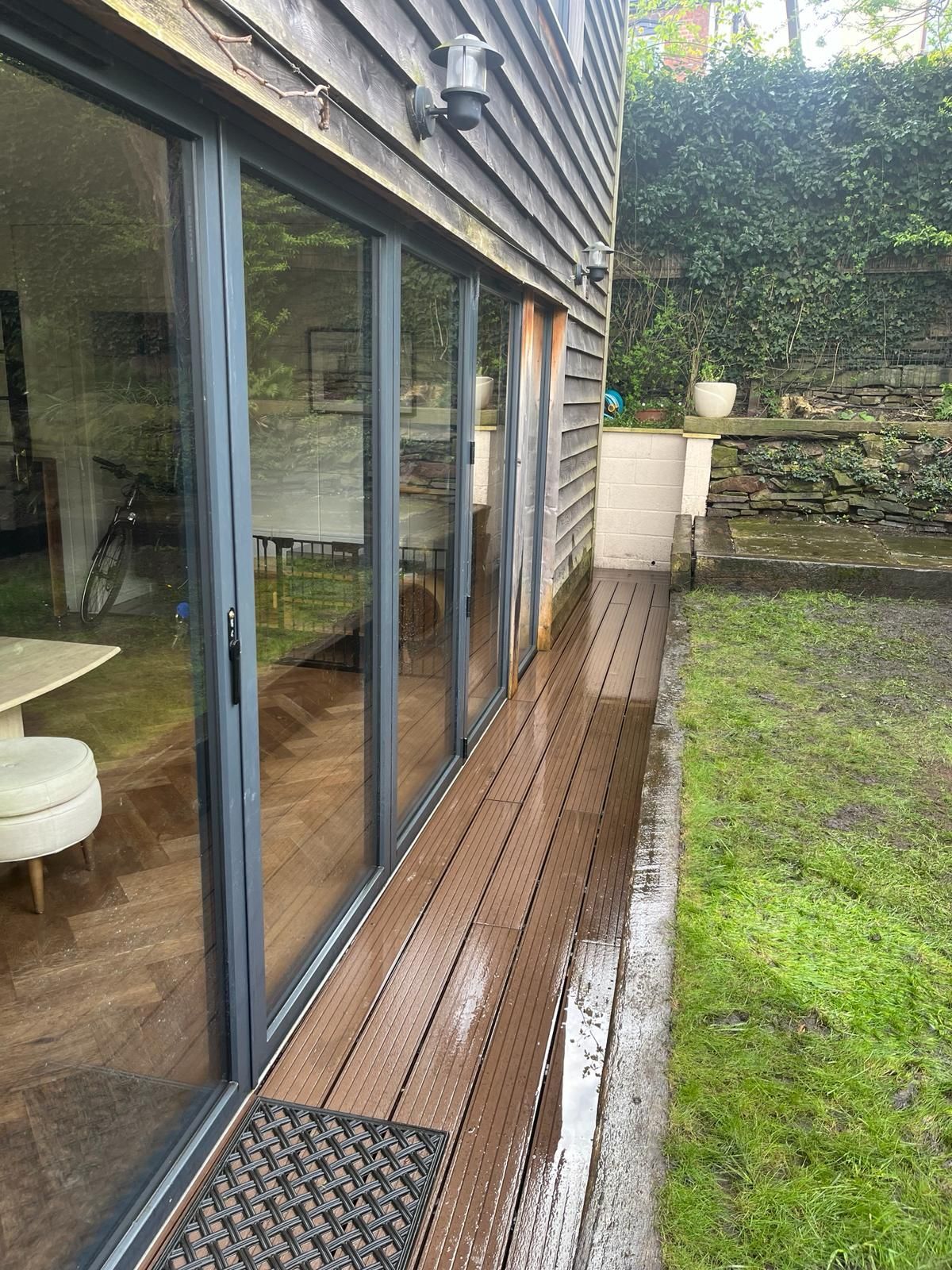 Decking Sheffield decking design to provide a dry path around the house