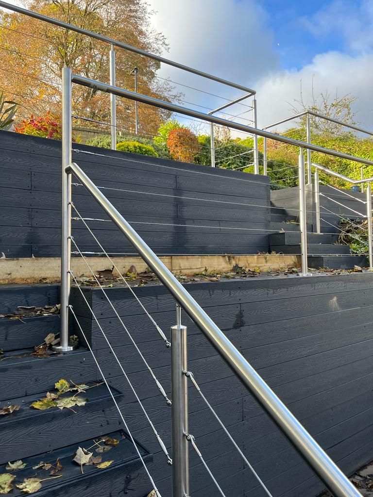 Decking Sheffield raised composite decking ideas with stainless steel and wire balustrade along steps
