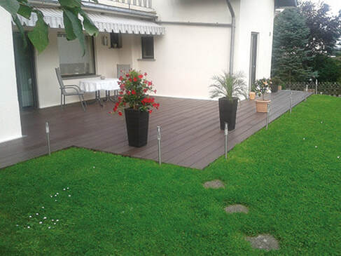 brown plastic decking going from house to lawn in Sheffield