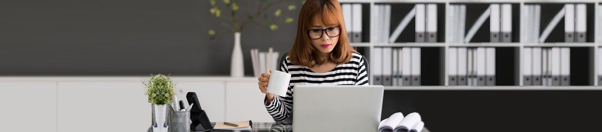 Lady wearing glasses and using a computer