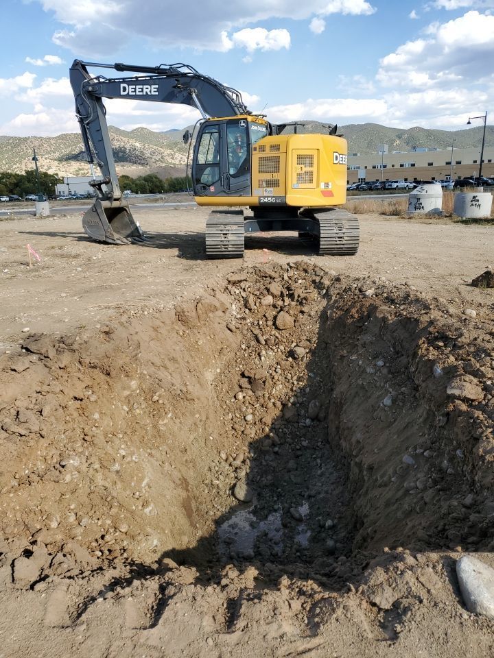 Excavator digging place for septic tank.