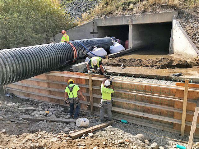 Workers building a culvert and retaining wall