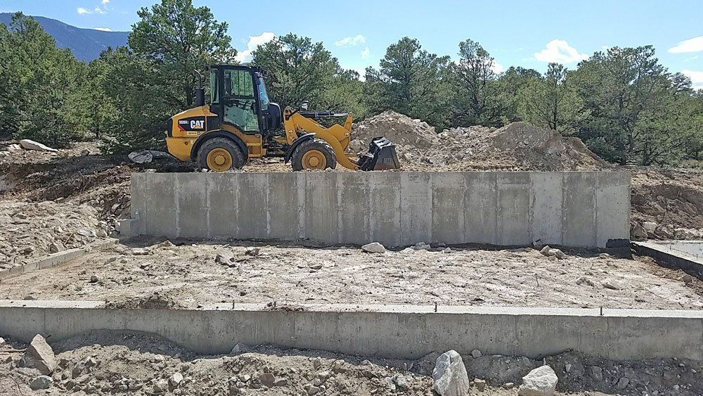 Cat moving dirt at foundation build