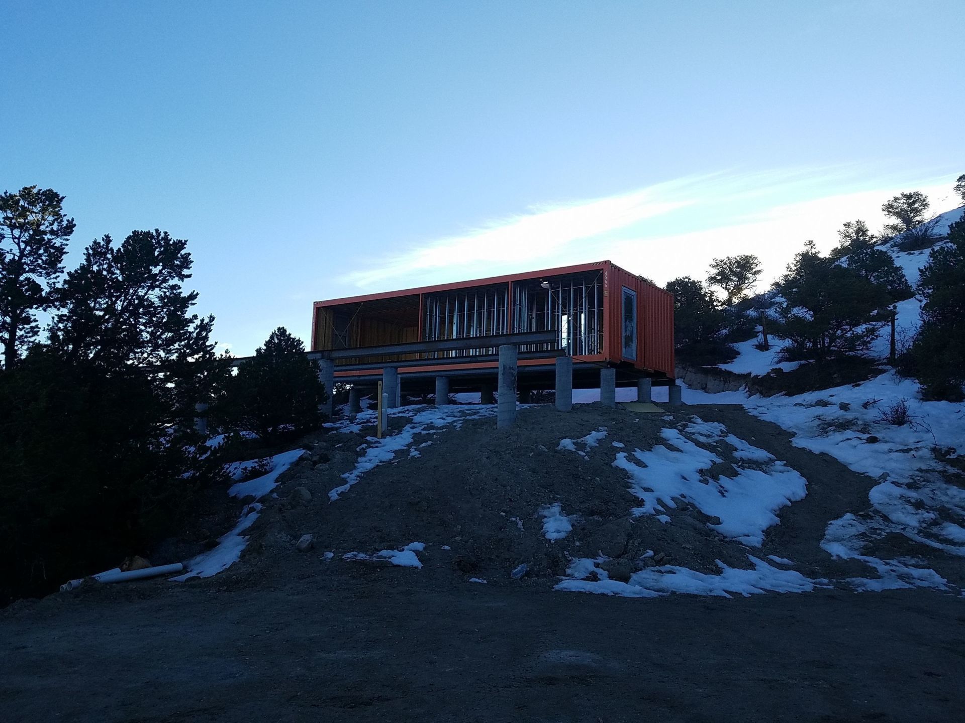 Building being being built on top of concrete pillar foundation