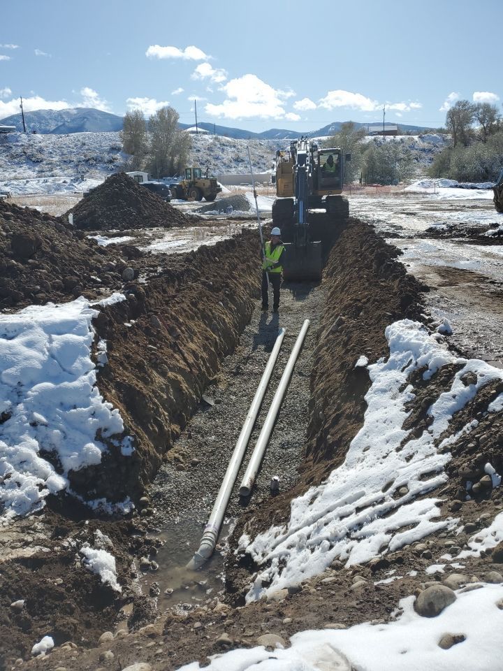 Pipe being laid by workers