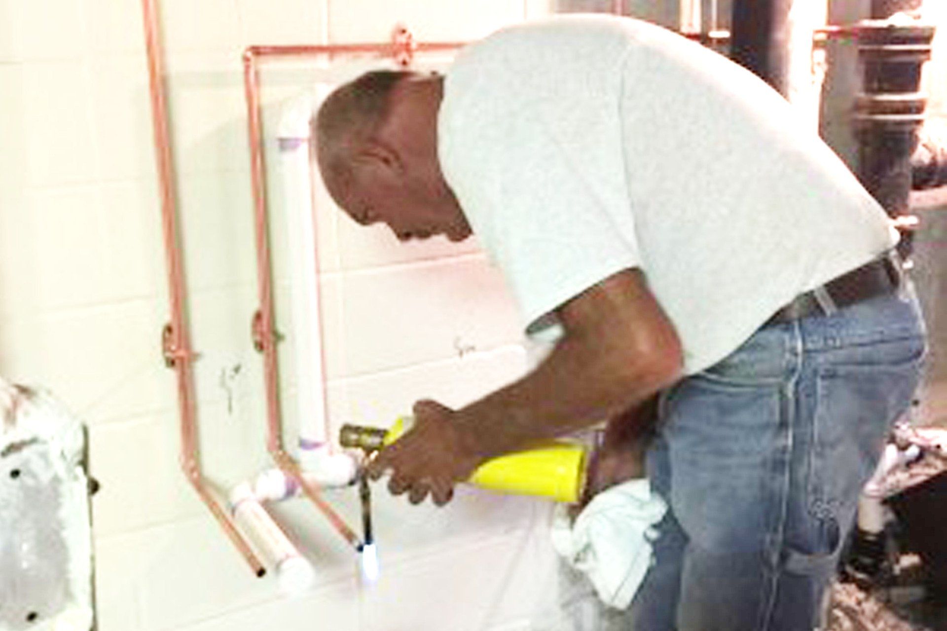 A Plumber Fixing A Faucet — Clarksville, TN — Jim Davis & Son Plumbing JDS Mechanical Inc.