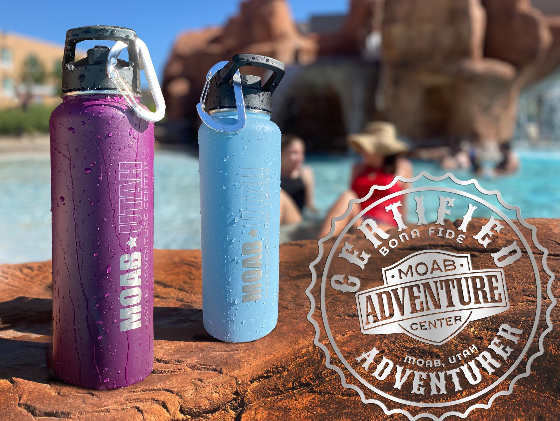 Two water bottles on a rock ledge near a pool, Moab Adventure Center logo.