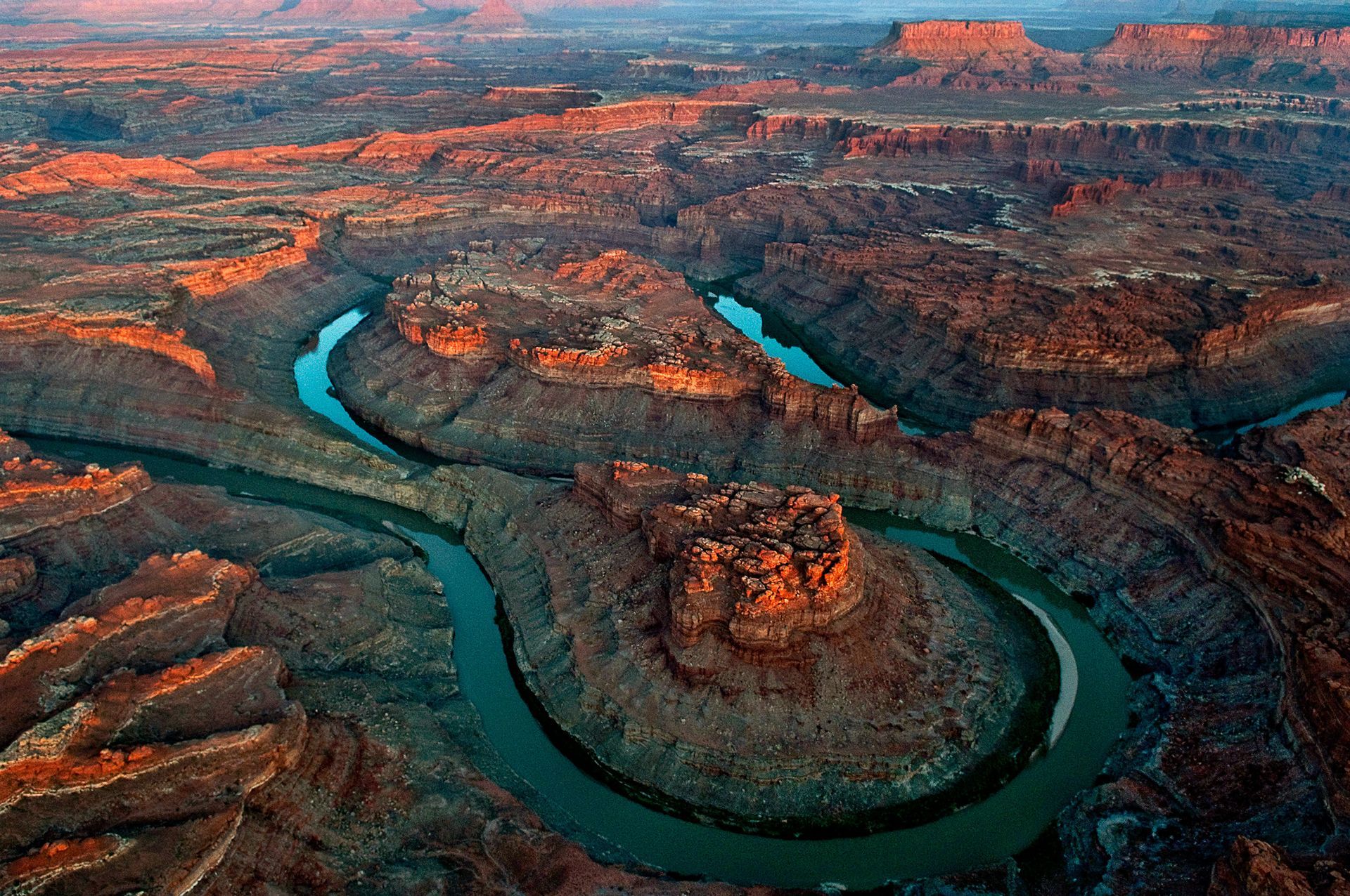 Canyonlands National Park, Utah: vast canyon formations with a winding river from an aerial perspective.
