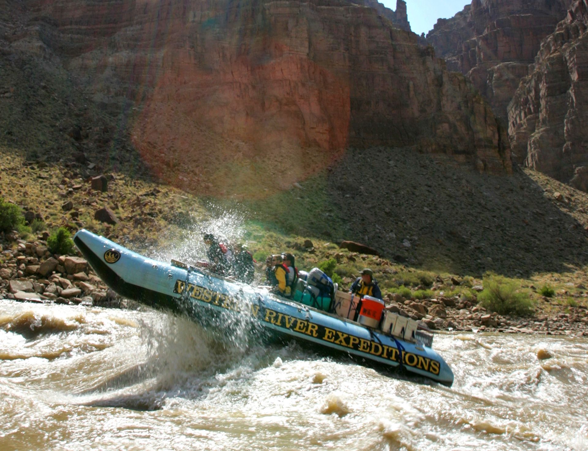 A raft splashes through whitewater on the Colorado River in Canyonlands National Park.