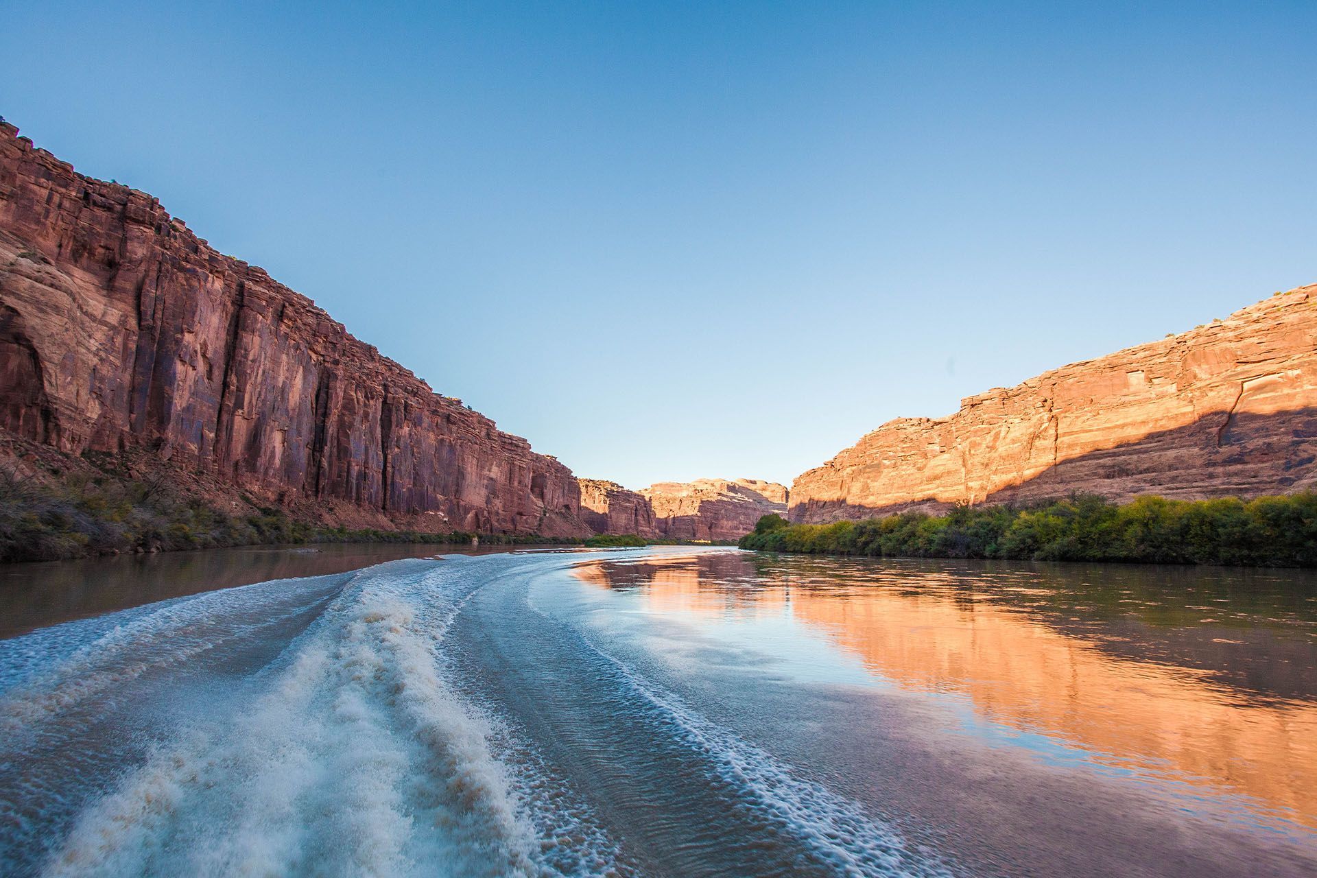 A group of people are riding a boat on a lake at night.