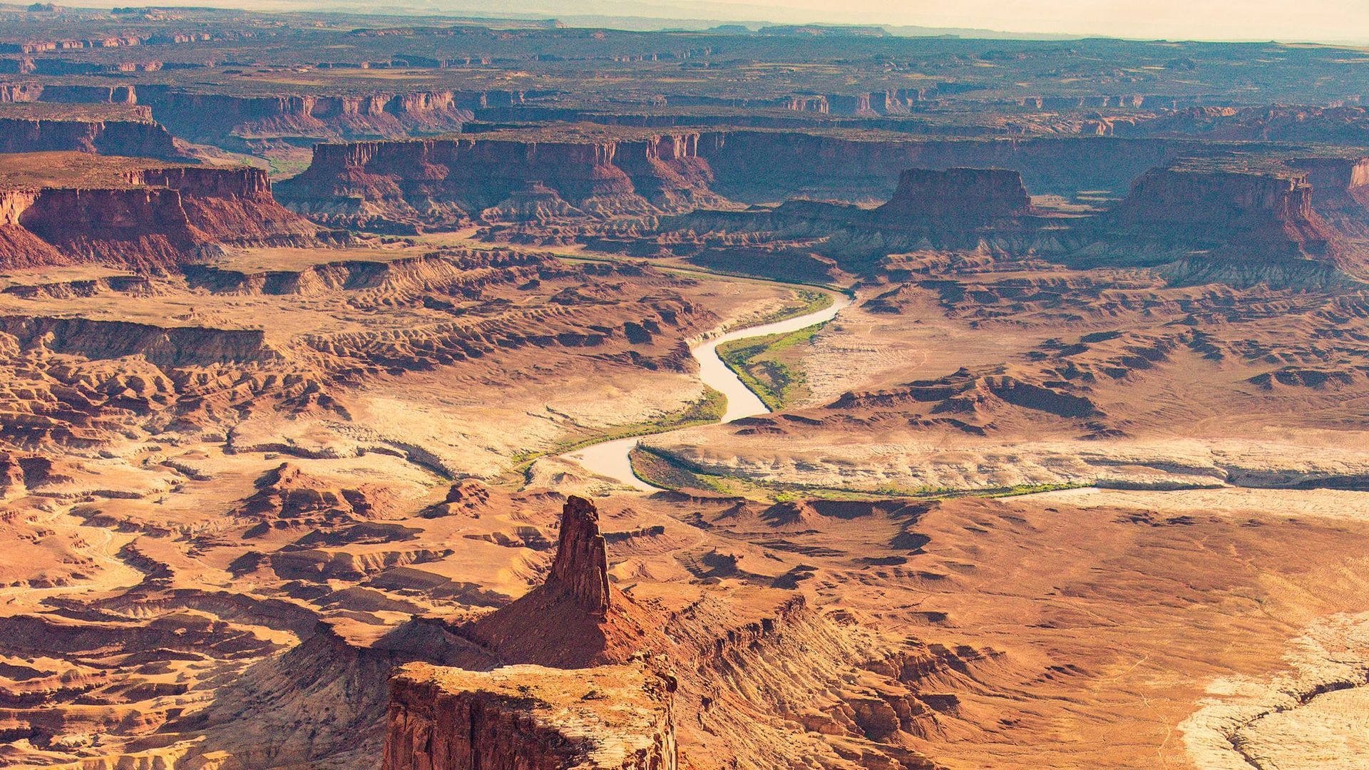 An aerial view of a desert landscape with a river running through it.