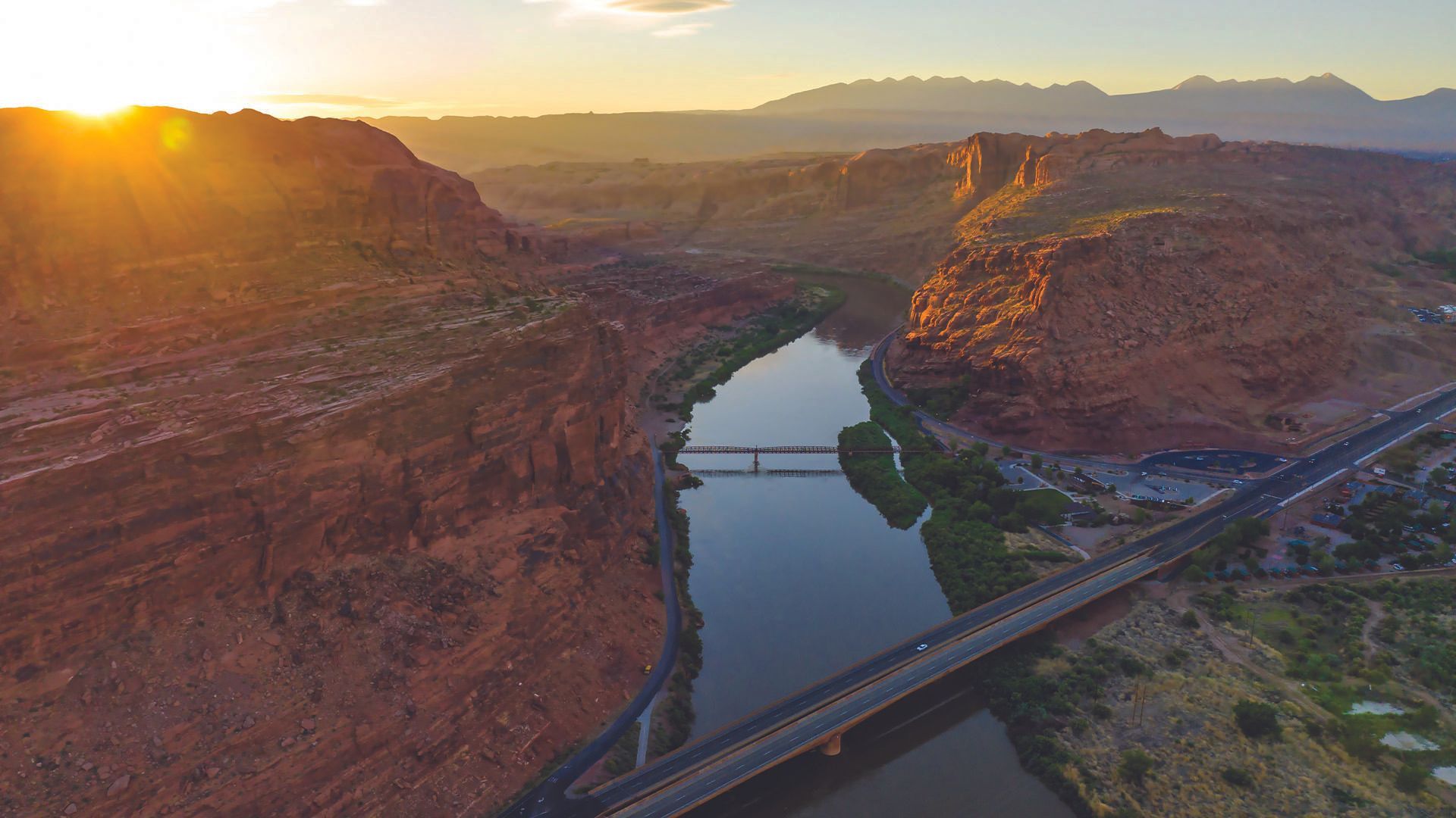An aerial view of the Colorado River with the highway bridge crossing into the city of Moab from the north end of town.