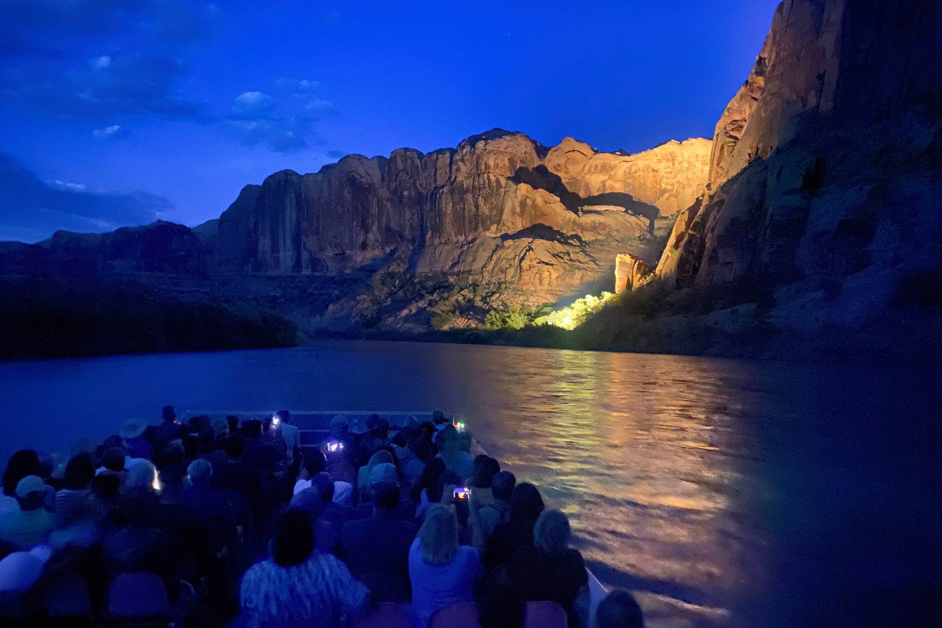 Unforgettable experience: Witnessing the majestic canyon walls lit up at night from a river boat.
