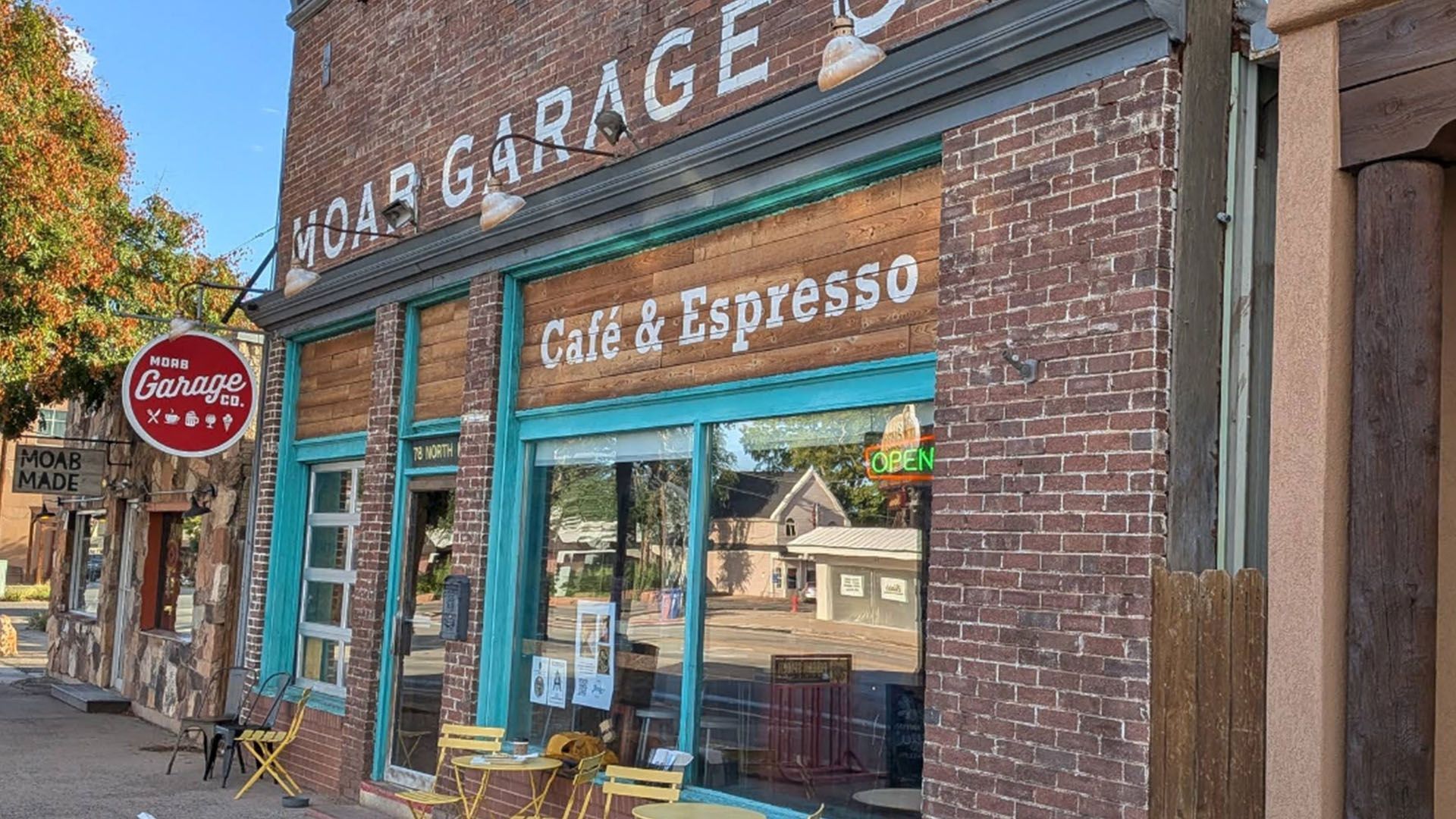 Exterior of Moab Garage Co restaurant with antiqued brick and wood and painted-on sign.