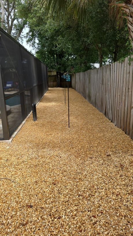 a pile of rocks on a wall with trees in the background