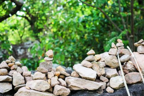 a pile of rocks on a wall with trees in the background