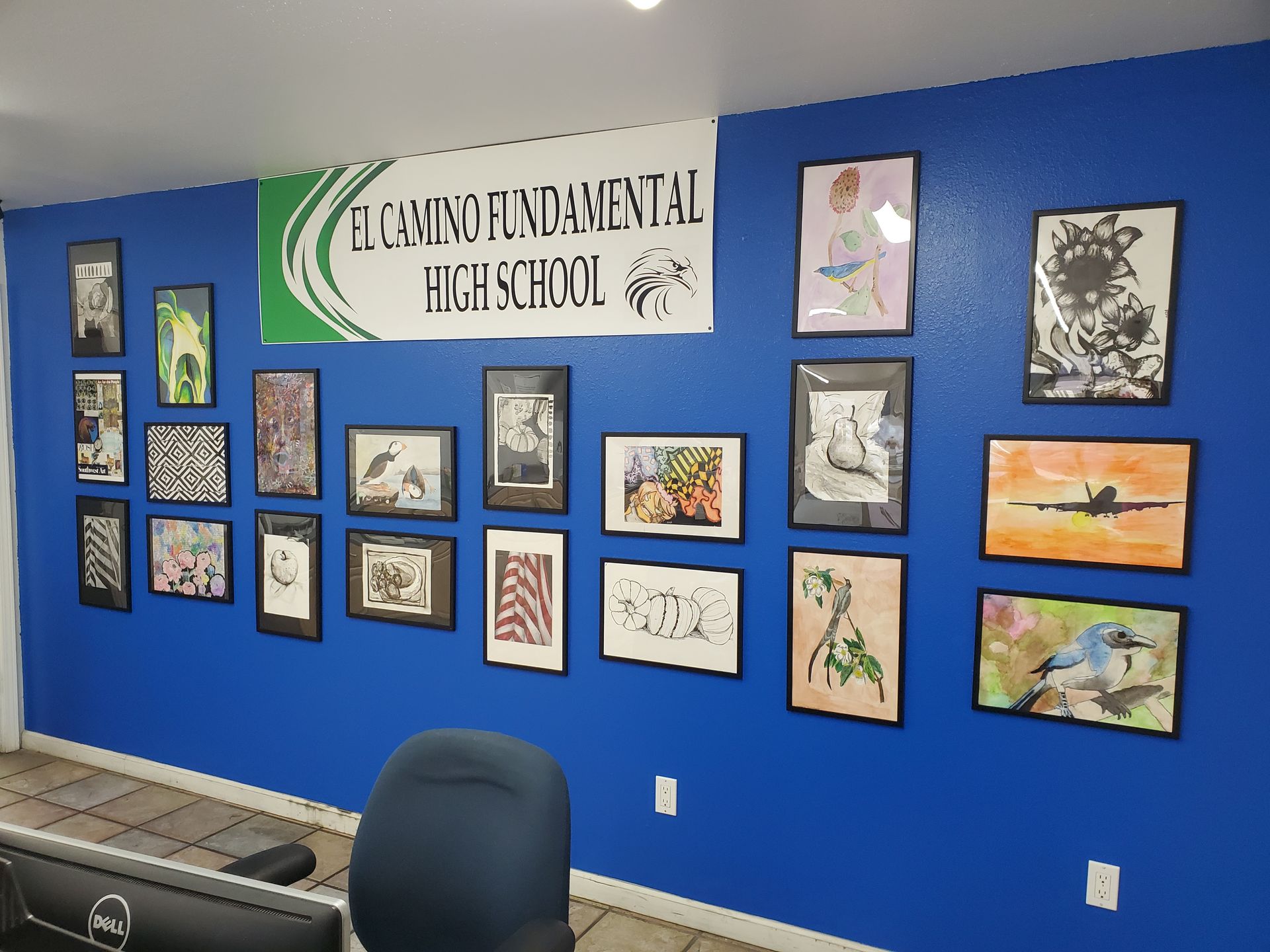 Blue wall with student art in frames, El Camino Fundamental High School sign above. | Hal's Auto Care