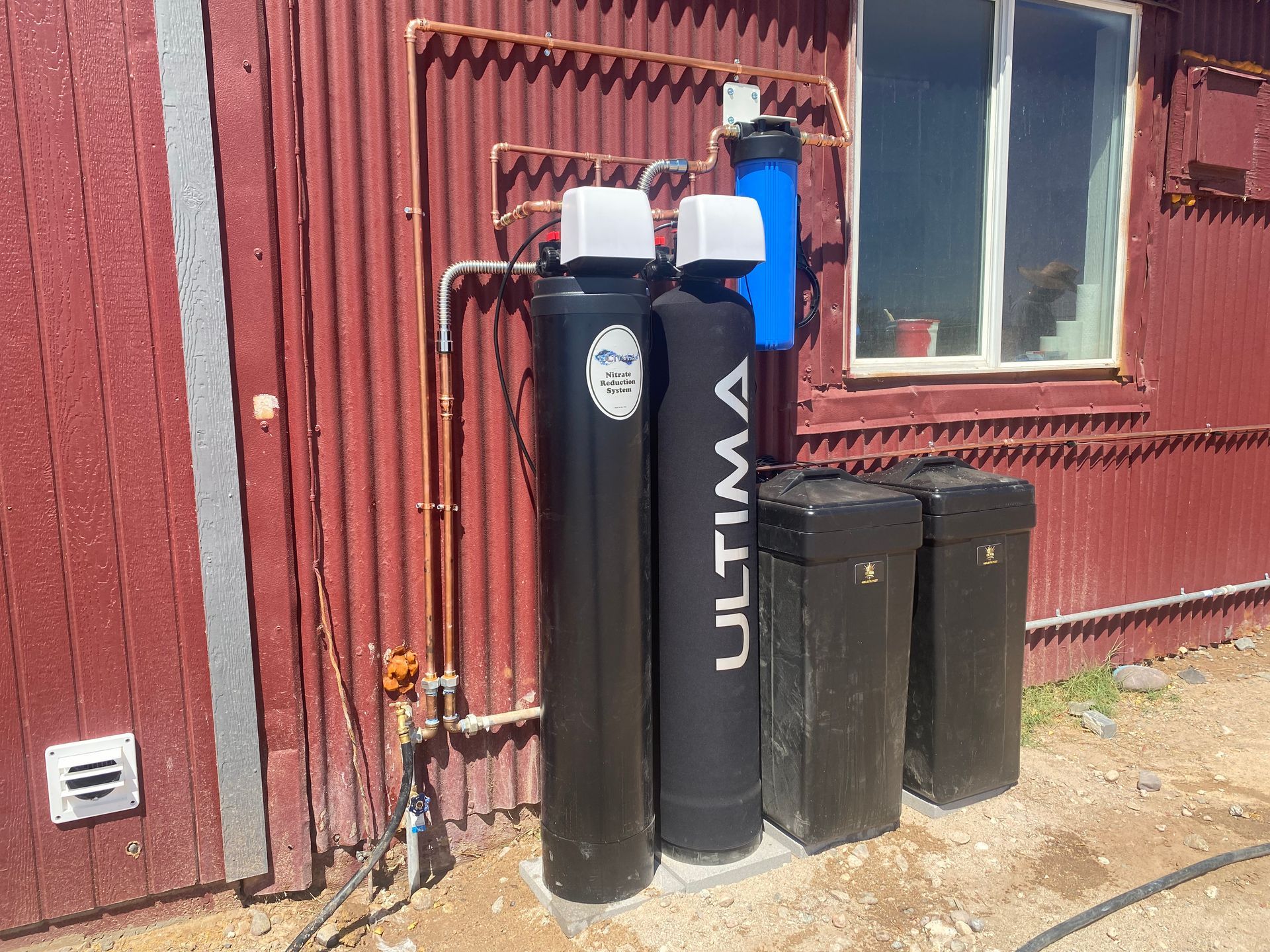 Black water softener outside the house.