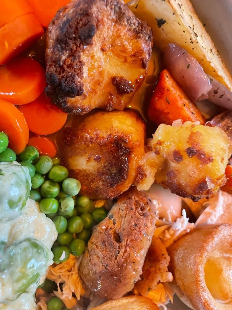 A close up of a plate of food with meat and vegetables.