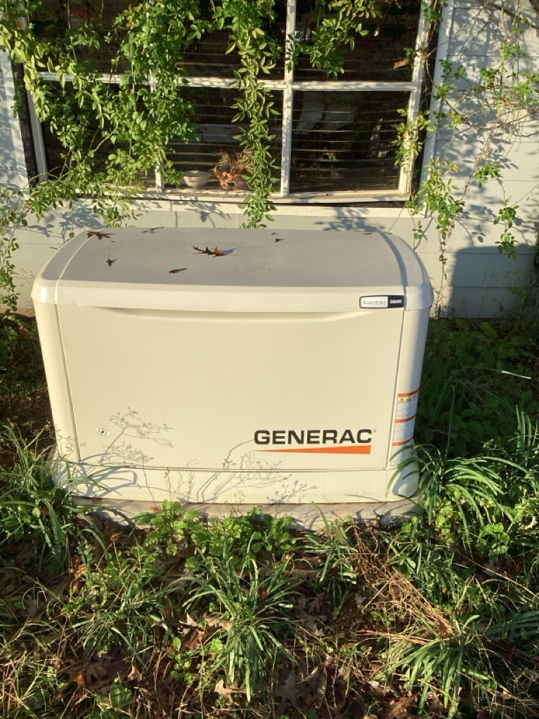 A group of air conditioners are sitting on top of a dirt field.