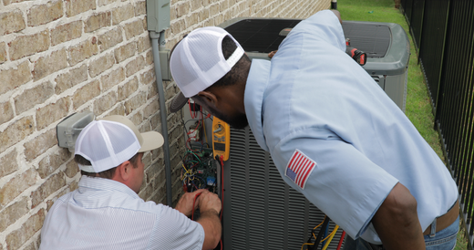 A large air conditioner is sitting on the side of a house.
