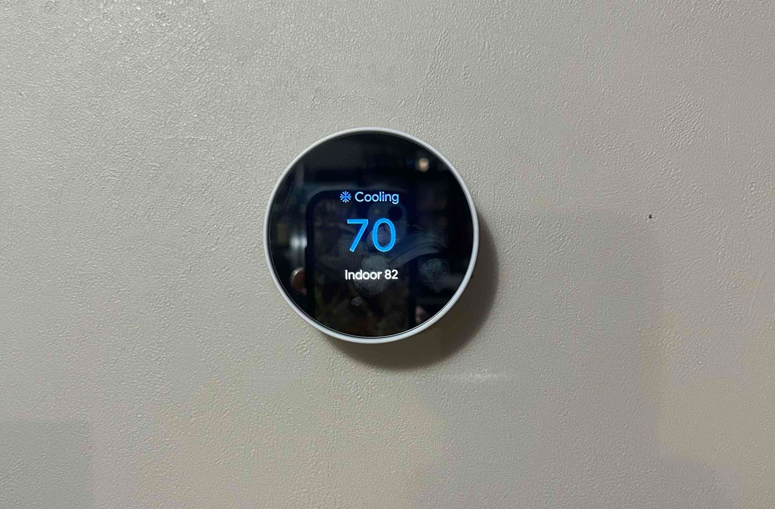 An air conditioner is sitting on the side of a house.