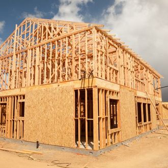 A house that is being built with a lot of wood