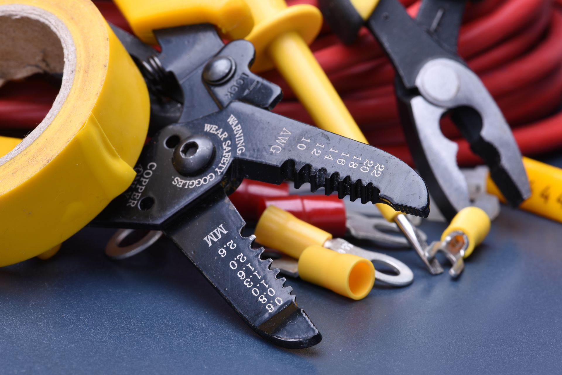 A pair of wire cutters sitting on top of a bunch of other tools