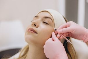 A woman is getting a facial treatment at a spa.