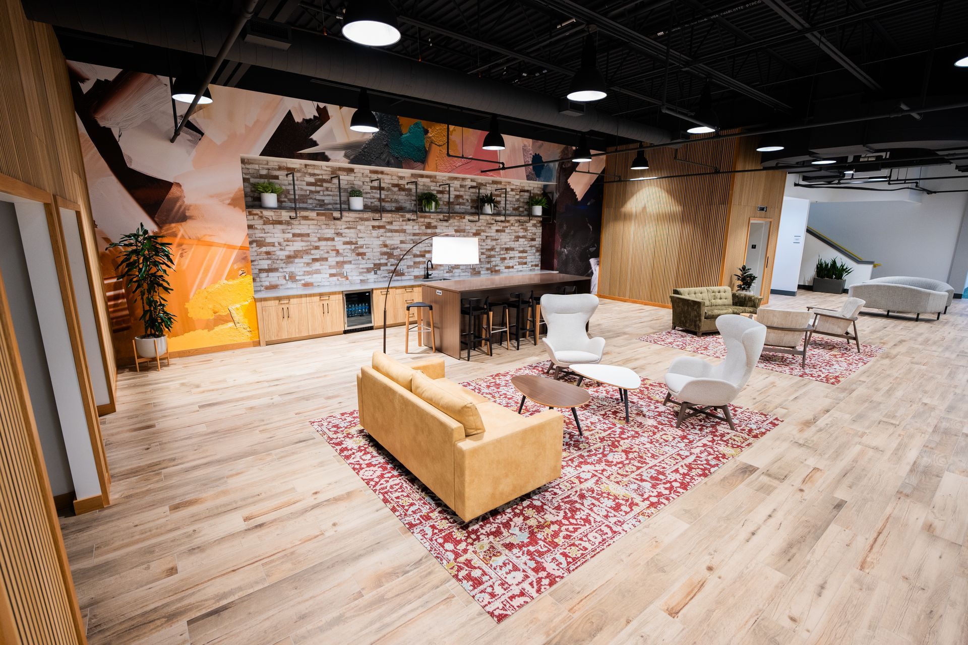 A living room with a couch , chairs , and a rug.
