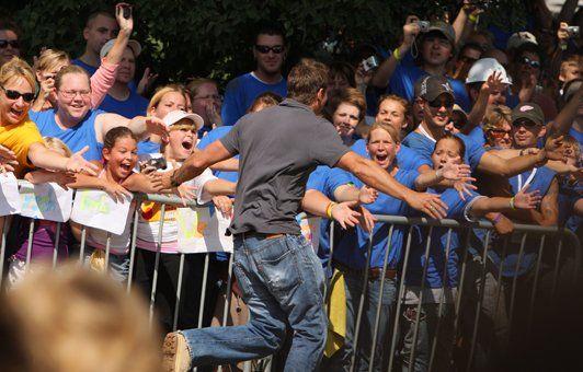A man running in front of a crowd of people